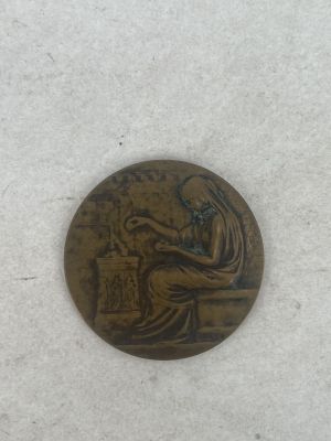 an old bronze coin with a woman sitting on a bench