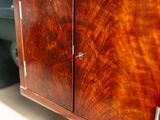 a wooden cabinet with two doors and a door handle on it