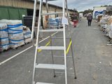 a ladder that is sitting on the side of the road