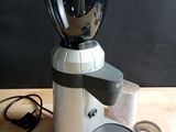 a coffee grinder sitting on a table next to a pair of scissors