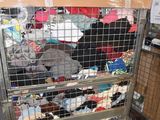 a large metal cage filled with lots of clothes