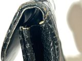 a black purse that is sitting on a table