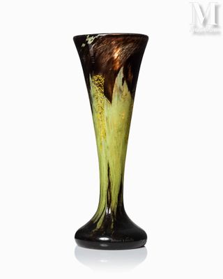 a black and yellow vase sitting on a white surface