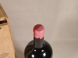 a bottle of wine sitting next to a wooden box
