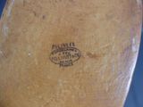 a close up of a wooden shoe with a label on it