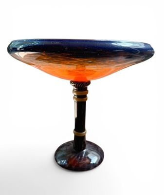 a blue and orange glass bowl sitting on a table