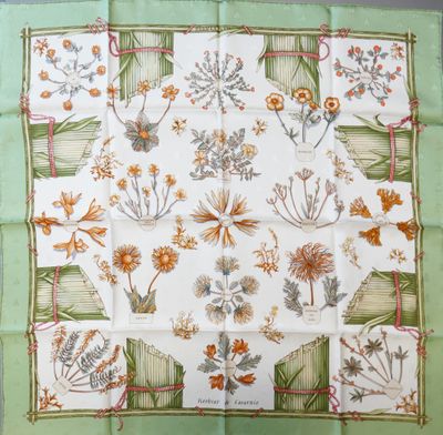 a close up of a green and white square with flowers on it