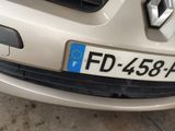 a white car with a blue license plate on the front of it