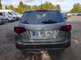 a silver car parked in a parking lot with other cars