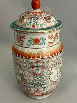 a large vase with a lid on a white table