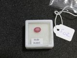 a small box with a pink stone inside of it