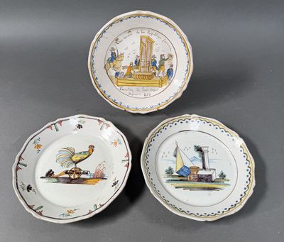 three plates with different designs on them sitting on a table