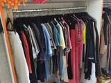 a rack of clothes on a shelf in a room