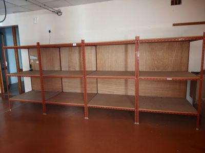 a room that has a bunch of shelves in it