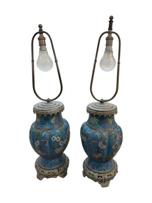 pair of blue and gold vases with a light bulb on top