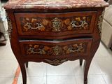 an antique chest of drawers with a marble top