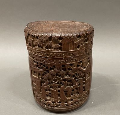 an old wooden box with carvings on it sitting on a table