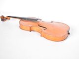 an old violin sitting on a white surface with a white background