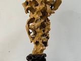 a sculpture made of wood on a pedestal in a room