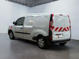 a white van with red stripes parked in a room