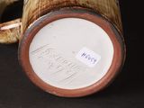 a close up of a vase with a tag on it