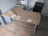a desk with a chair and a book on it