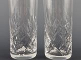 pair of crystal tumblers on a black background