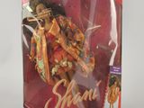 an image of a doll in a box with a picture of a woman on it