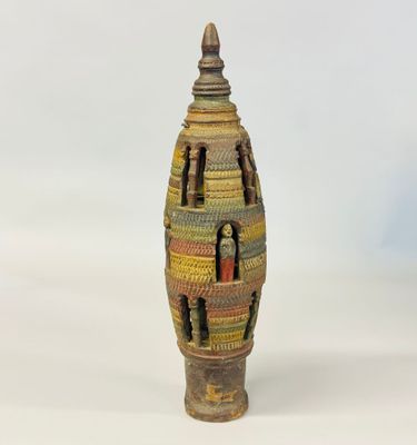 a small vase that is sitting on a white surface