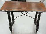 a small table with a wooden top on a white floor