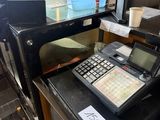 a cash register sitting on top of a counter