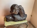 a statue of a man and a woman sitting on a bench