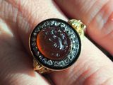 a person holding a ring with a picture on it