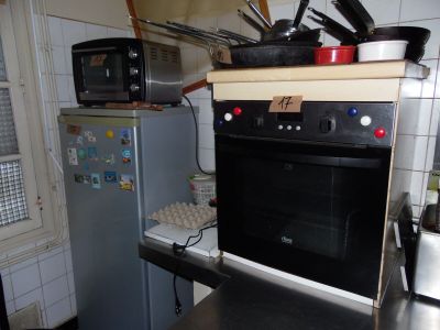 a kitchen with a stove, microwave, and a refrigerator in it