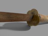 a close up view of a brass pipe with a wooden handle