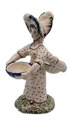 a figurine of a woman holding a bowl