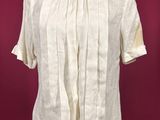 a white shirt on a mannequin stand against a red background