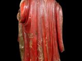 statue of a man holding a stick in his right hand