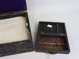 a small wooden box with a purple lining and a small wooden box with a purple lining