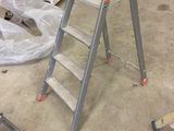 a ladder that is sitting in the middle of a room