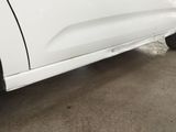 a white truck parked in a garage with its door open