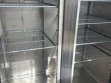 a refrigerator that has two doors open in a kitchen