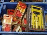 many different tools in a blue bin on the floor