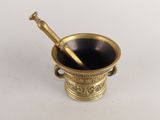 an antique brass mortar with a pestula in it on a white surface