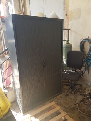 an image of a room with a cabinet and a chair in it