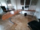 a desk with a computer and a chair in a room