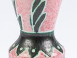 a pink vase with a black and green design on it