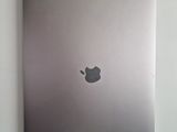 an apple laptop computer sitting on top of a table next to a mouse