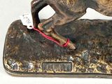 a statue of a horse that is running on a rock