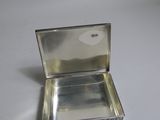a small silver box that is sitting on a table